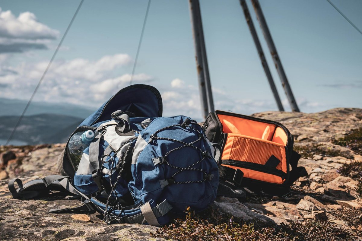 Camera and lenses fitted into custom foam dividers inside a hiking-grade photo pack