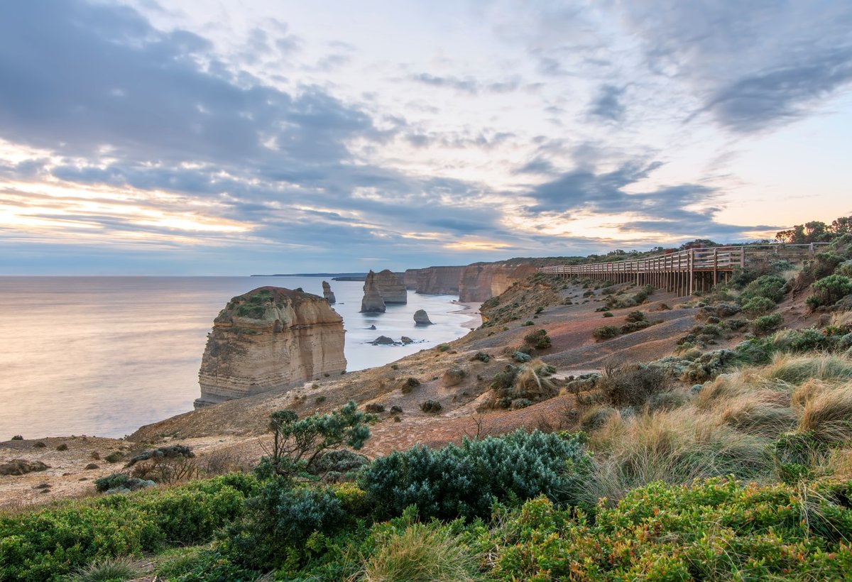 The Twelve Apostles at dusk from the main viewing platform, long exposure smoothing the Southern Ocean under a pastel sky