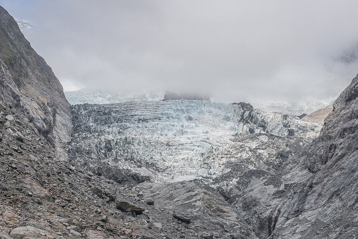 The icefall of Franz Josef Glacier between rock walls under cloud, Westland Tai Poutini National Park