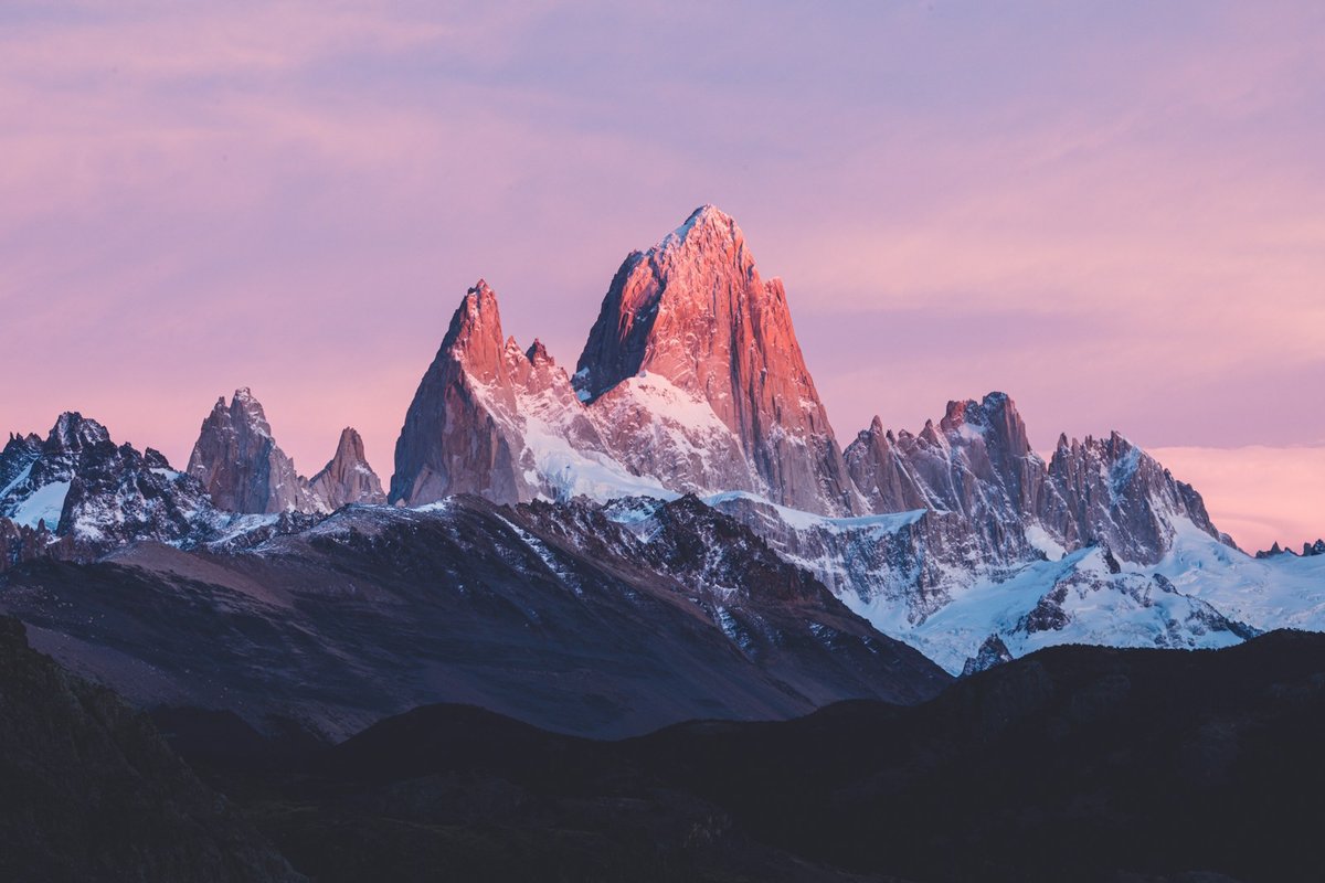 Pink dawn alpenglow on the granite spires of Cerro Fitz Roy, Los Glaciares National Park, Argentina